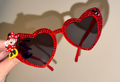 Red heart-shaped rhinestone sunglasses fully covered in sparkling crystals